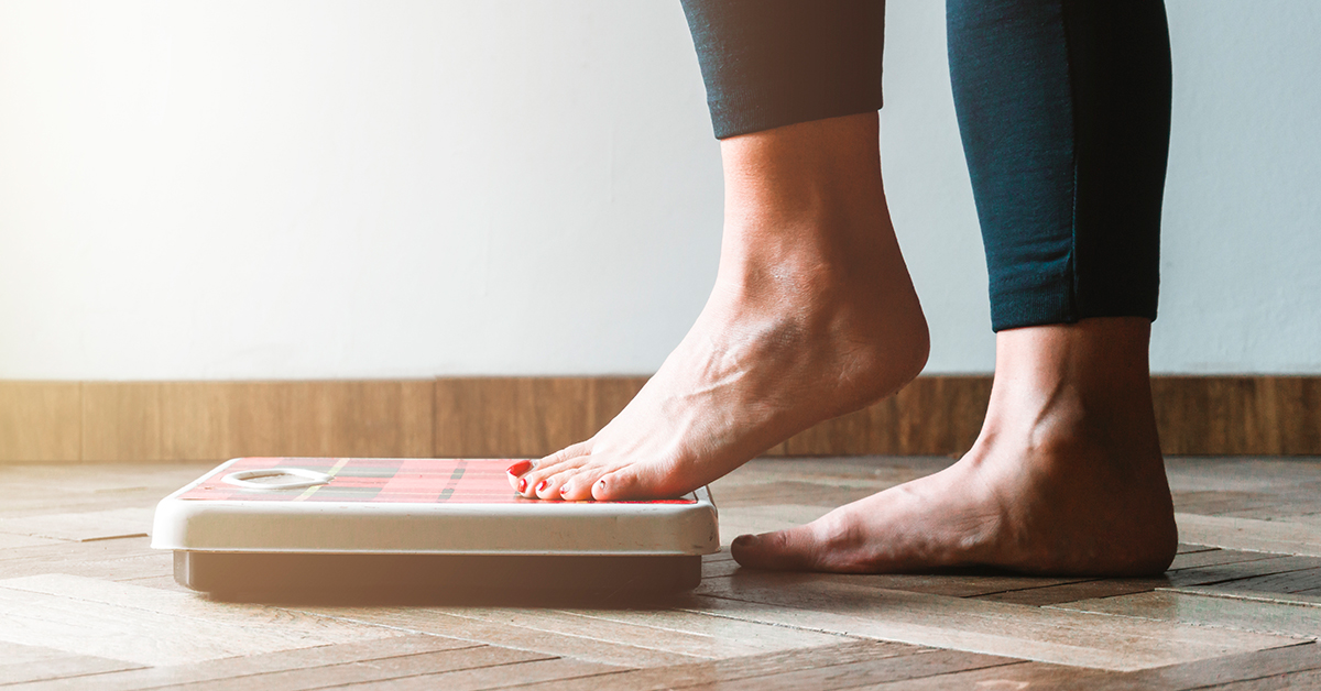 Person stepping onto weight scale