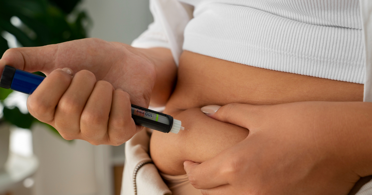 A person injects a GLP-1 medication into their abdomen.